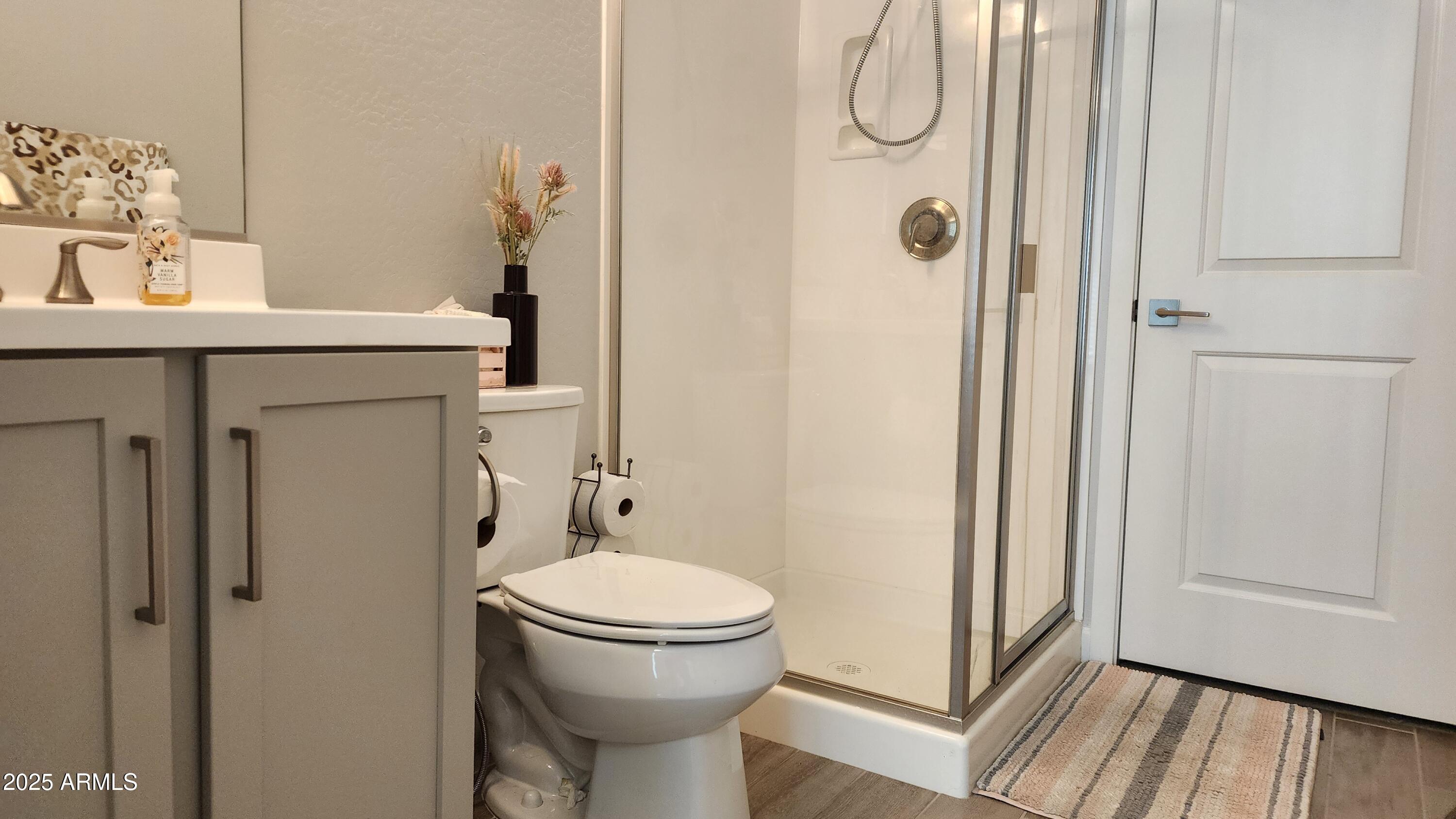 14400 West Bloomfield Road Surprise, AZ 85379 - Photo 29 of 38 a bathroom with a granite countertop toilet a sink and a mirror