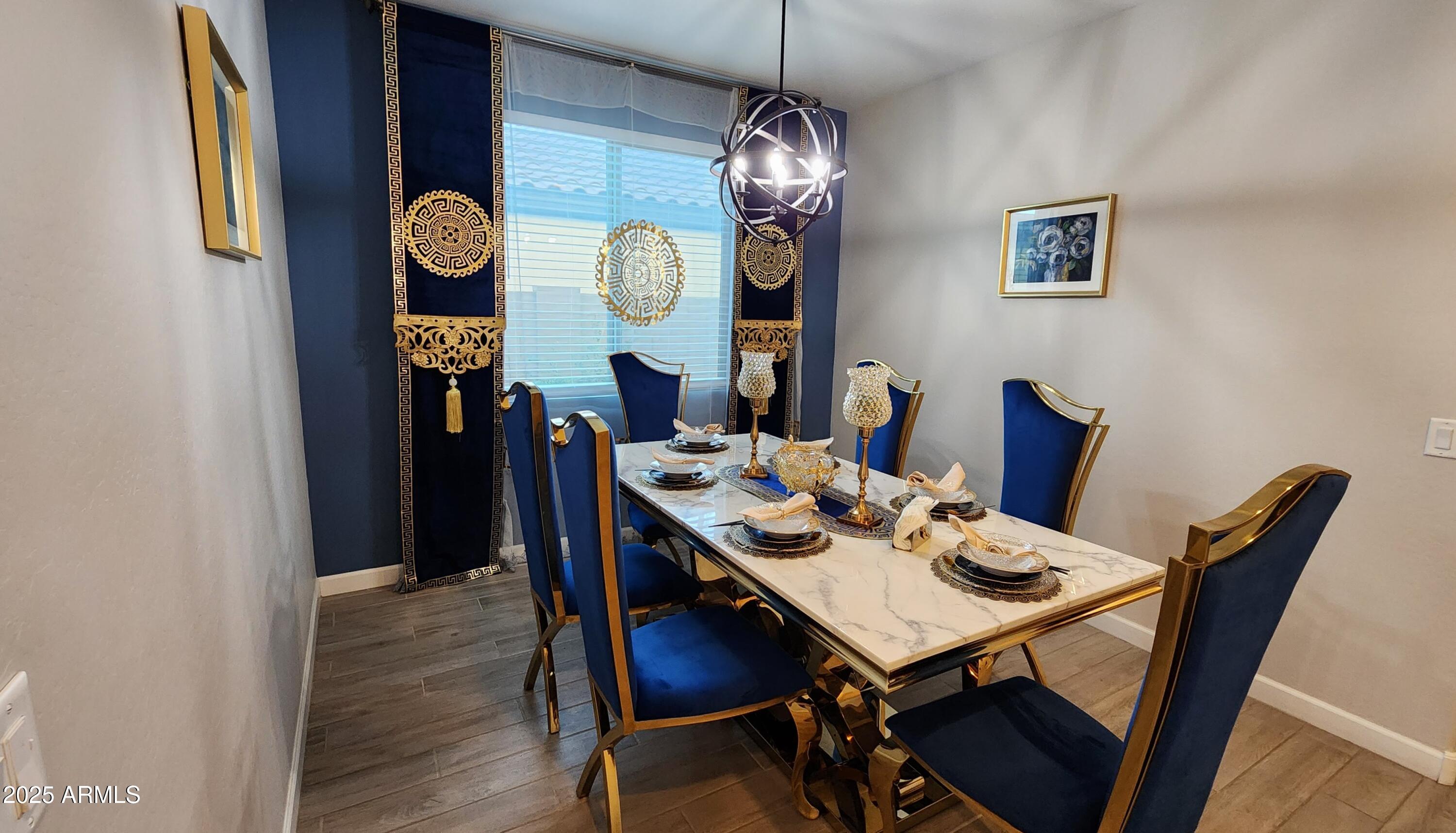 14400 West Bloomfield Road Surprise, AZ 85379 - Photo 3 of 38 a view of a dining room with furniture and chandelier