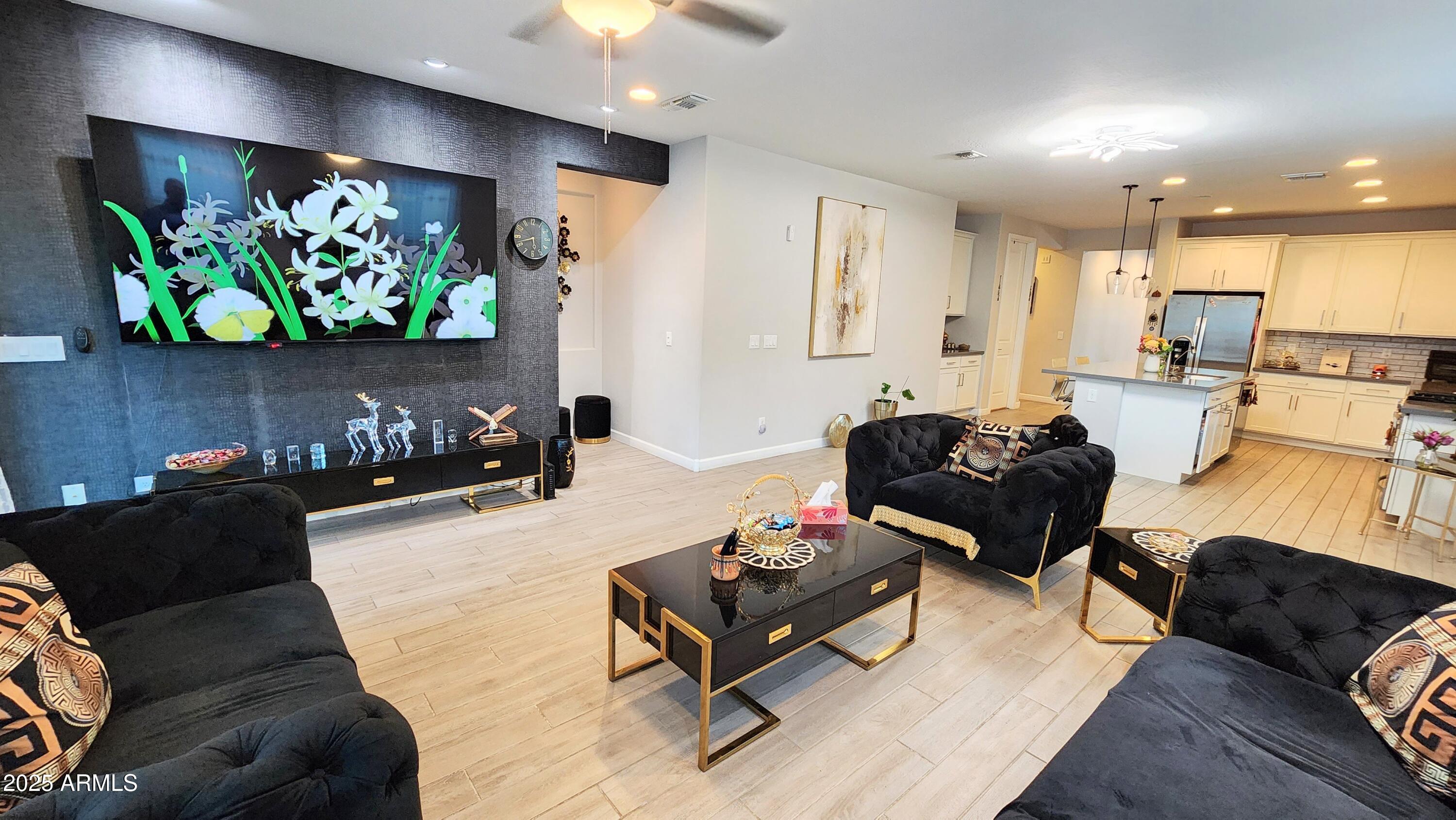 14400 West Bloomfield Road Surprise, AZ 85379 - Photo 10 of 38 a living room with furniture fireplace and a flat screen tv