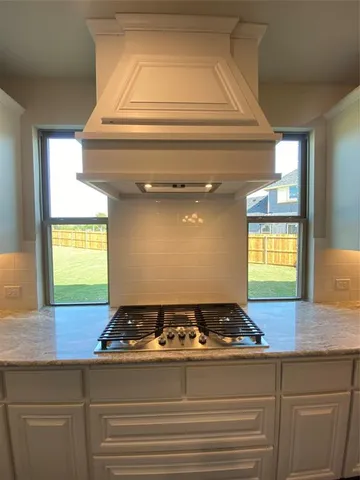 a kitchen with stainless steel appliances granite countertop a sink and a refrigerator