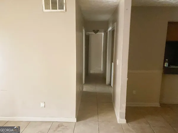 a view of a hallway with some storage and utility
