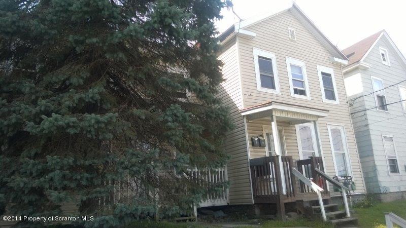 206 Ridge Street Honesdale, PA 18431 - Photo 2 of 25 a view of a brick house with a yard and wooden fence