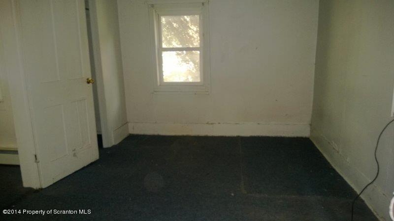 206 Ridge Street Honesdale, PA 18431 - Photo 22 of 25 an empty room with wooden floor and windows