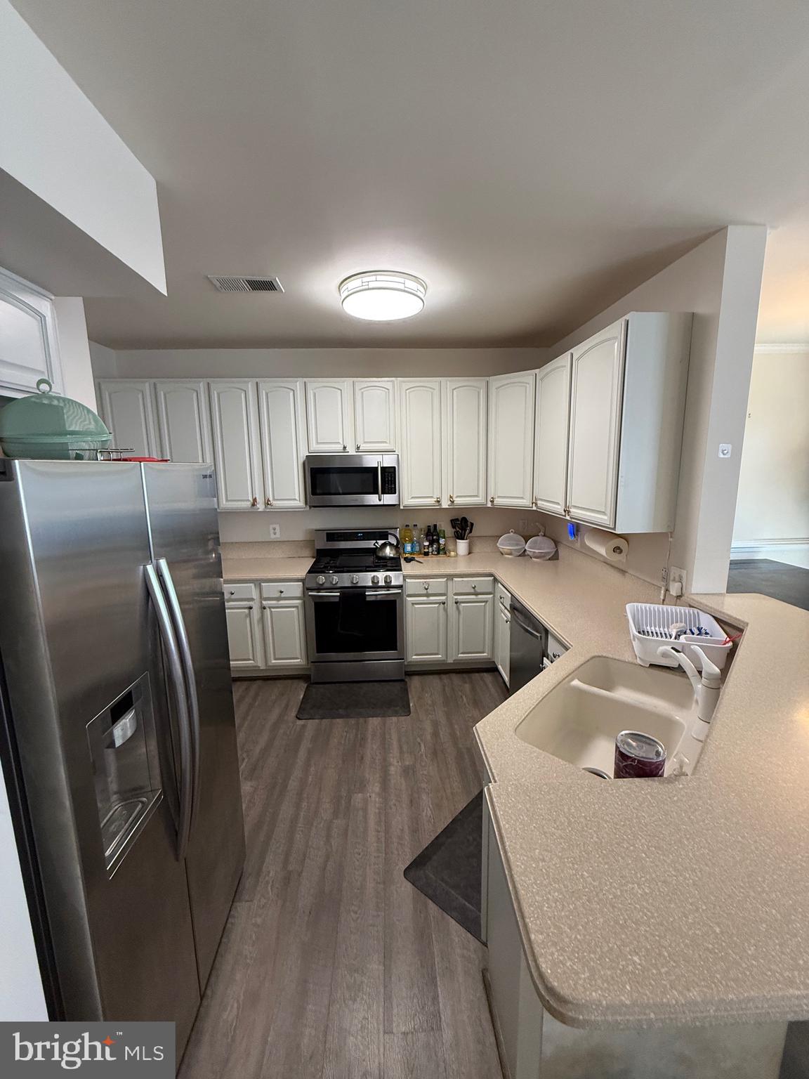 4617 Hummingbird Lane, Unit 110 Fairfax, VA 22033 - Photo 12 of 45 a kitchen with wooden cabinets and stainless steel appliances