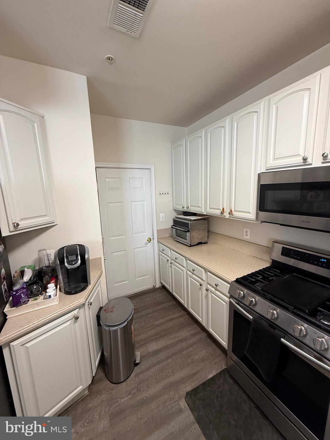 4617 Hummingbird Lane, Unit 110 Fairfax, VA 22033 - Photo 13 of 45 a kitchen with a stove and a refrigerator