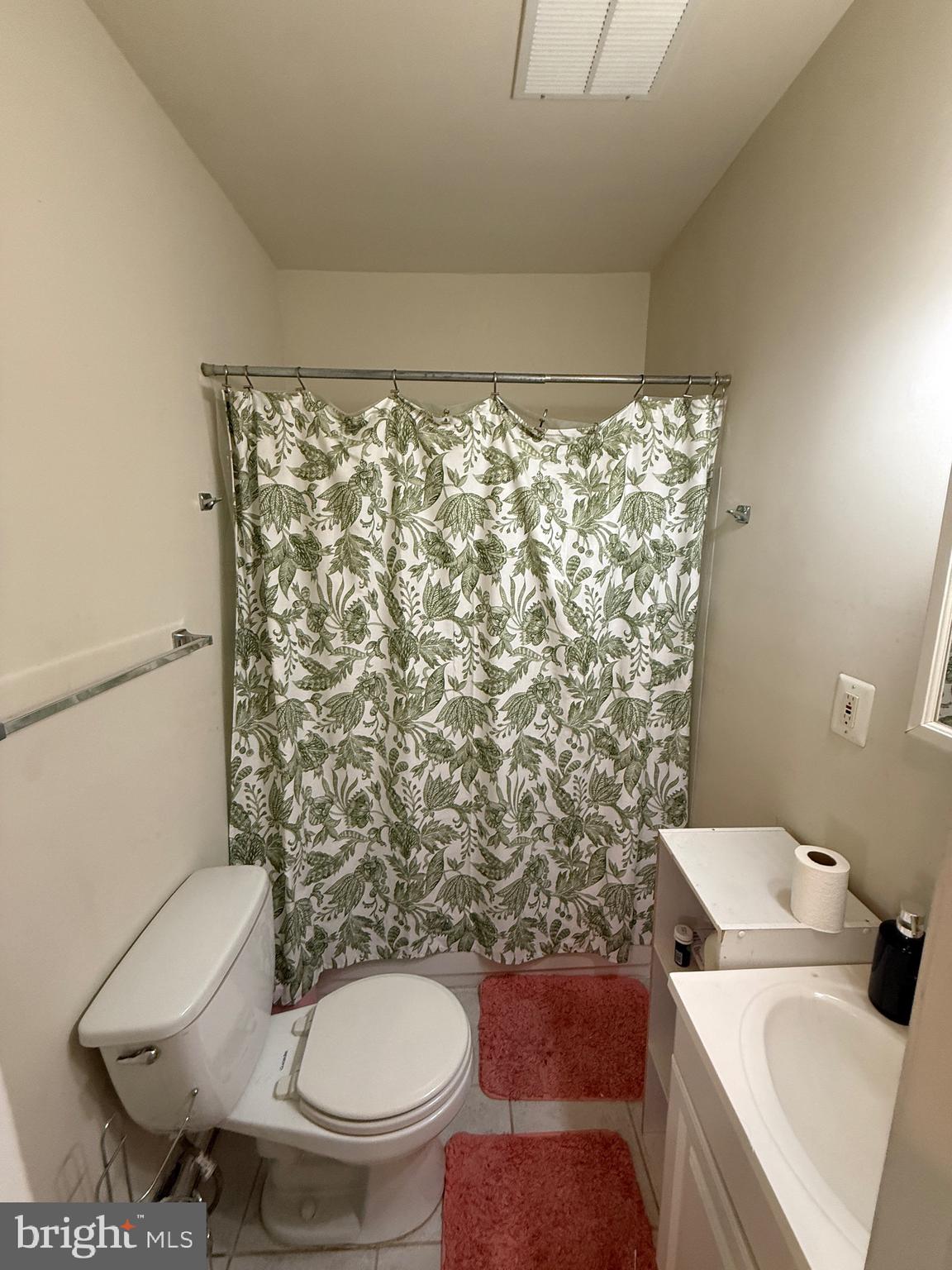 4617 Hummingbird Lane, Unit 110 Fairfax, VA 22033 - Photo 19 of 45 a white toilet sitting next to a shower curtain
