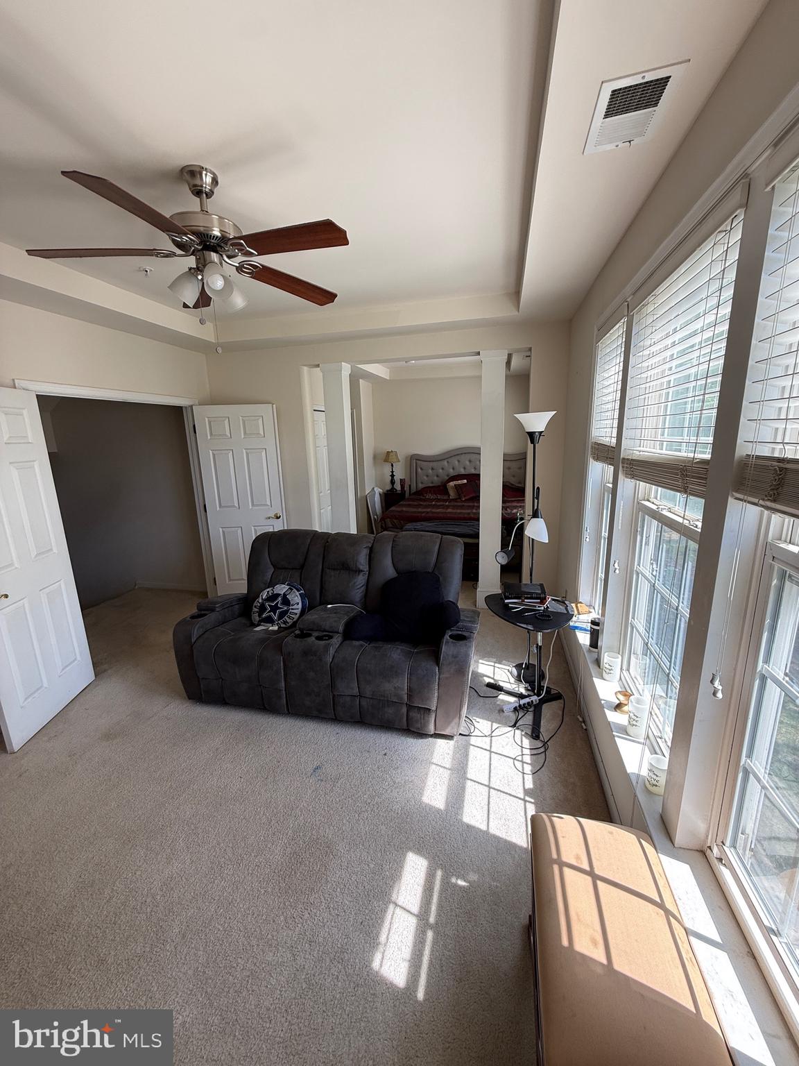 4617 Hummingbird Lane, Unit 110 Fairfax, VA 22033 - Photo 26 of 45 a living room with furniture and a floor to ceiling window
