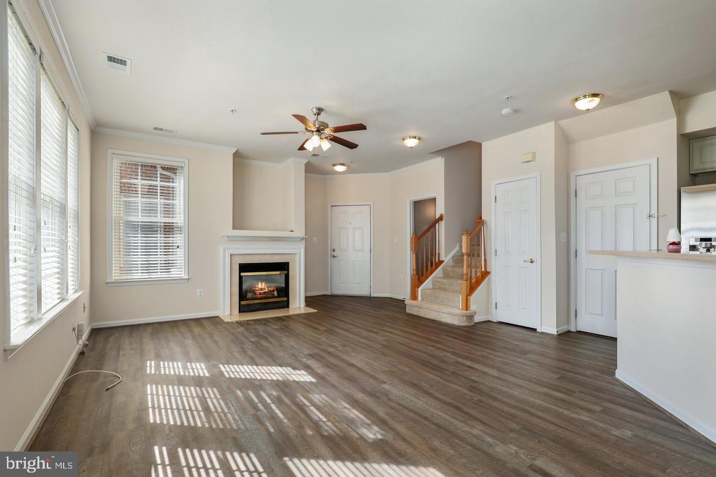 4617 Hummingbird Lane, Unit 110 Fairfax, VA 22033 - Photo 3 of 45 a view of an empty room with wooden floor fireplace and a window