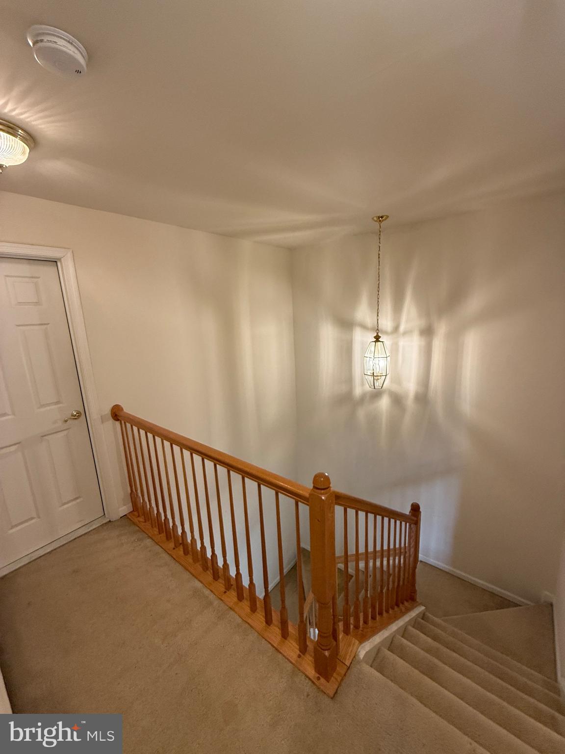 4617 Hummingbird Lane, Unit 110 Fairfax, VA 22033 - Photo 39 of 45 a view of staircase with railing and a chandelier