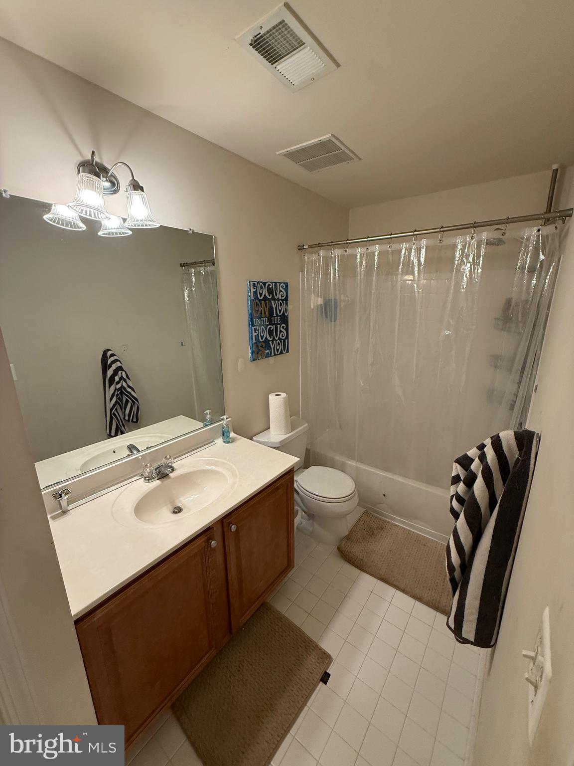 4617 Hummingbird Lane, Unit 110 Fairfax, VA 22033 - Photo 40 of 45 a spacious bathroom with a double vanity sink a mirror and a bathtub