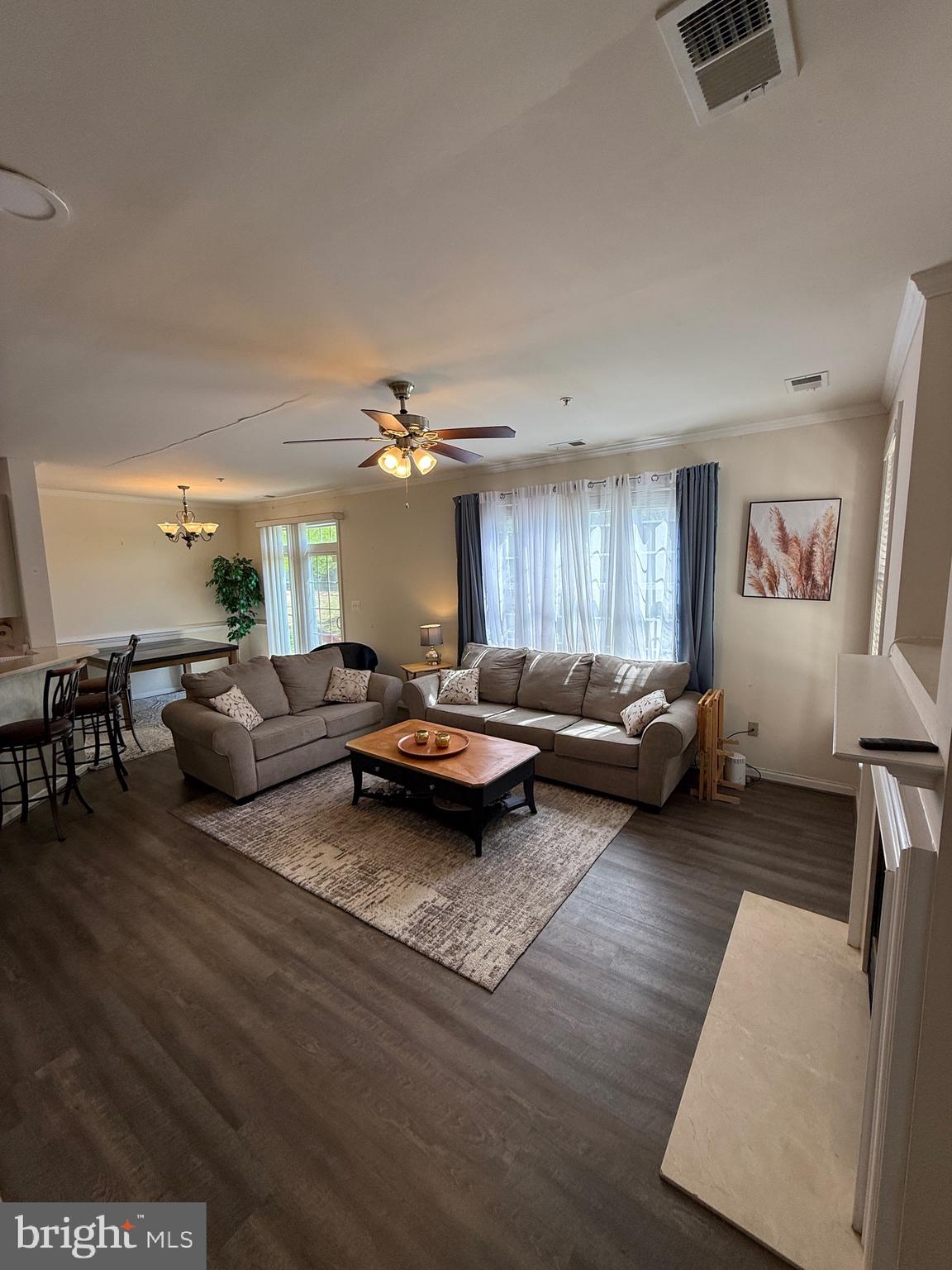4617 Hummingbird Lane, Unit 110 Fairfax, VA 22033 - Photo 7 of 45 a living room with furniture hard wood floor and a ceiling fan