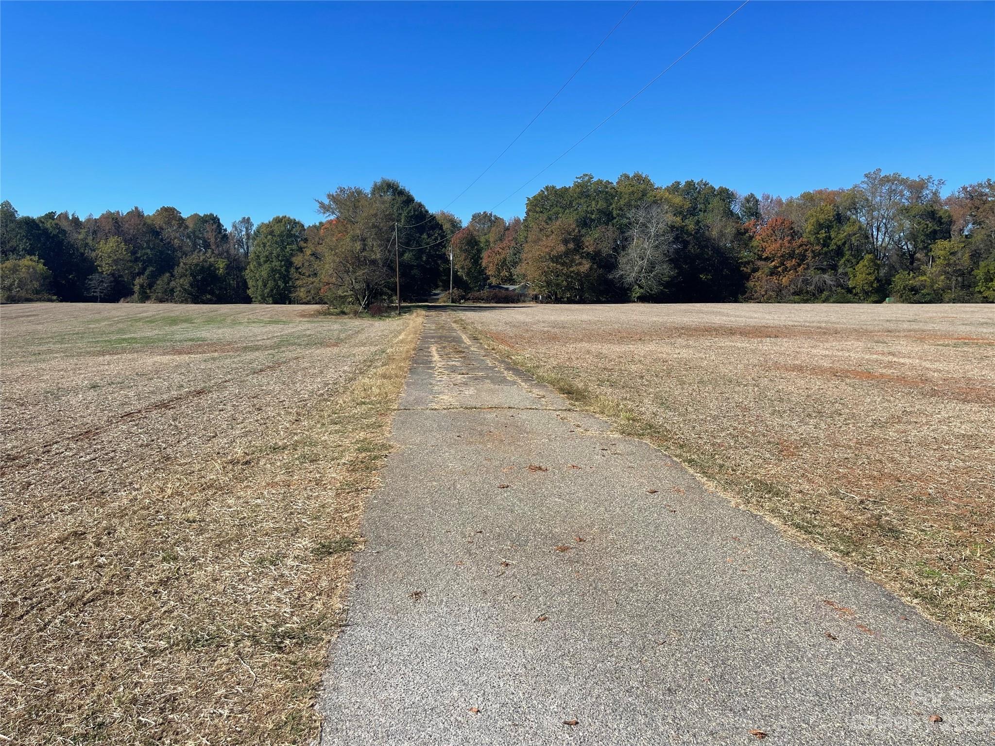 2640 Graham Road, Unit 4 Mount Ulla, NC 28125 - Photo 2 of 7 a view of dirt field with trees in the background