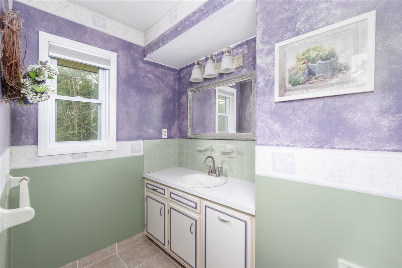 1959 Shutterlee Mill Road Staunton, VA 24401 - Photo 11 of 50 a bathroom with a sink a vanity and a painting on the wall