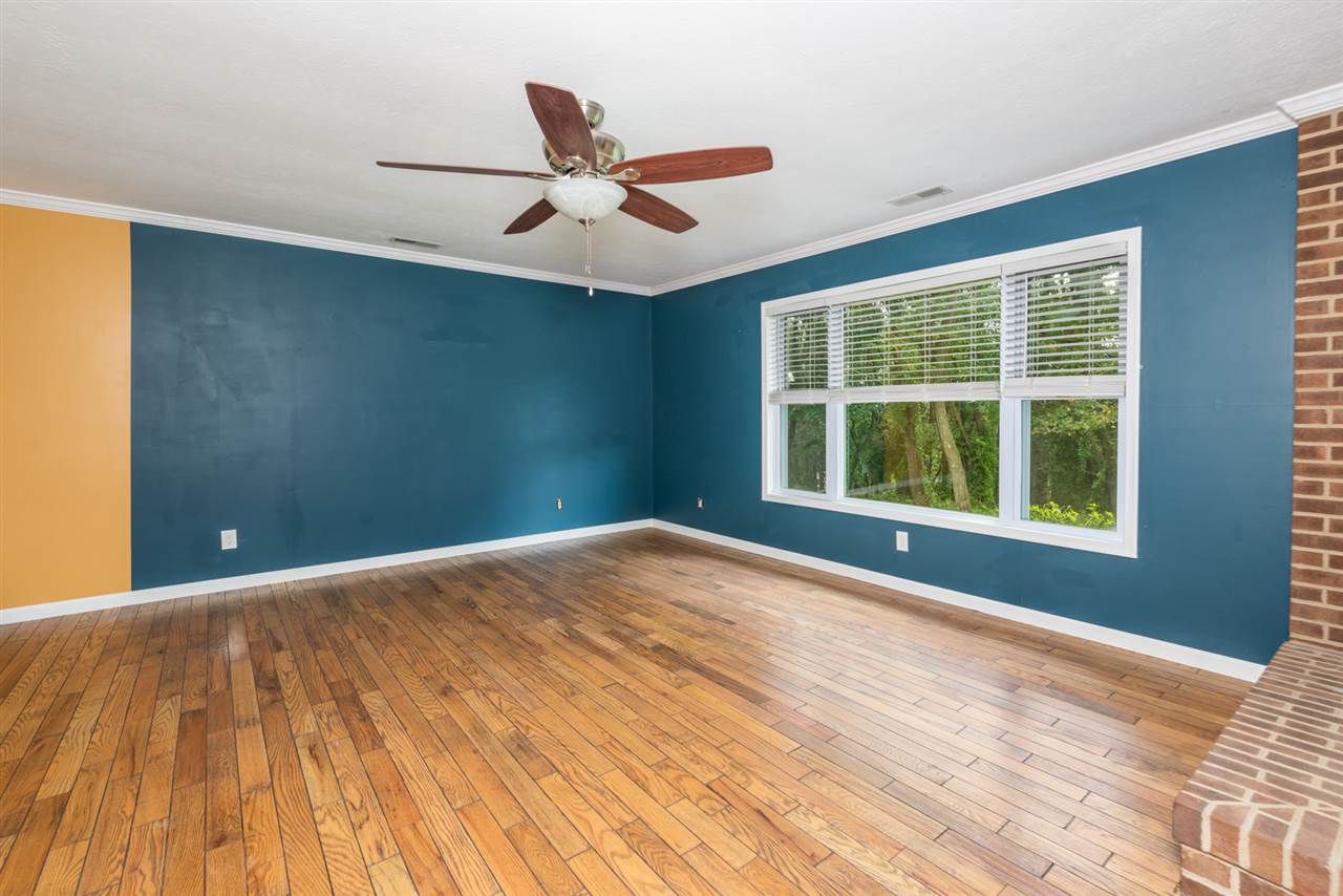 1959 Shutterlee Mill Road Staunton, VA 24401 - Photo 19 of 50 a view of an empty room with a window and wooden floor