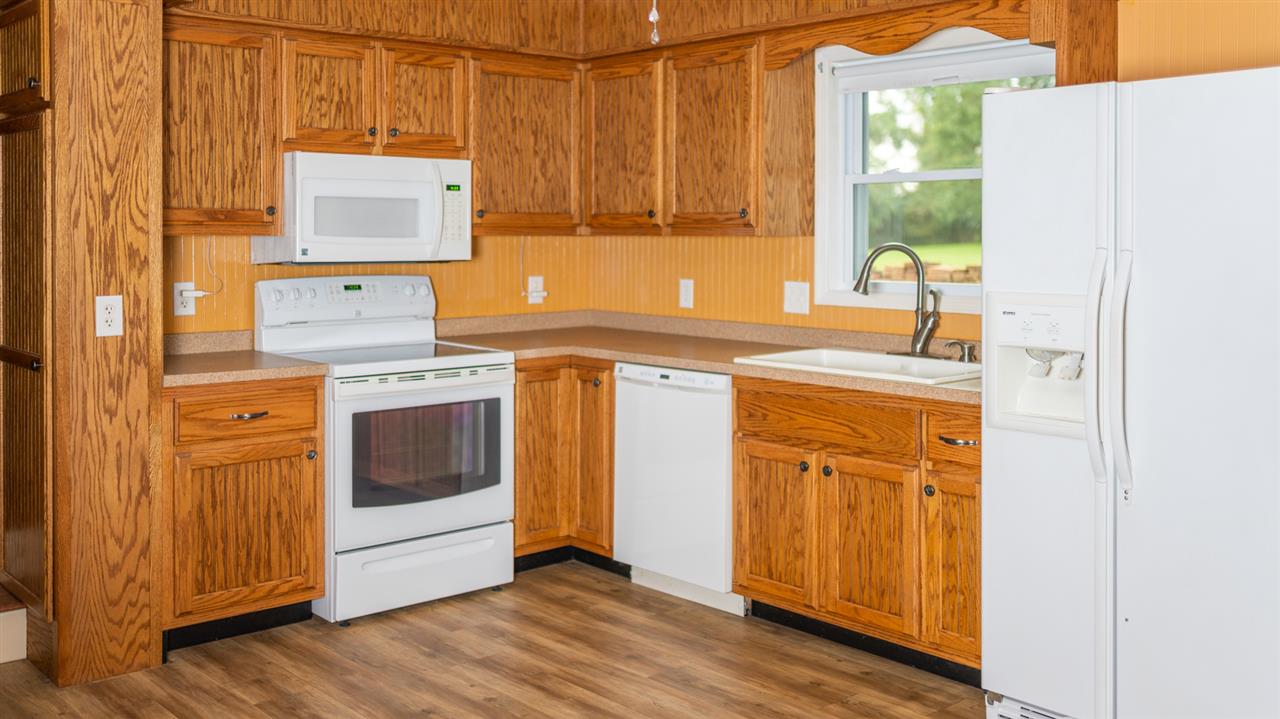 1959 Shutterlee Mill Road Staunton, VA 24401 - Photo 23 of 50 a kitchen with stainless steel appliances a stove a sink and a refrigerator with wooden floor