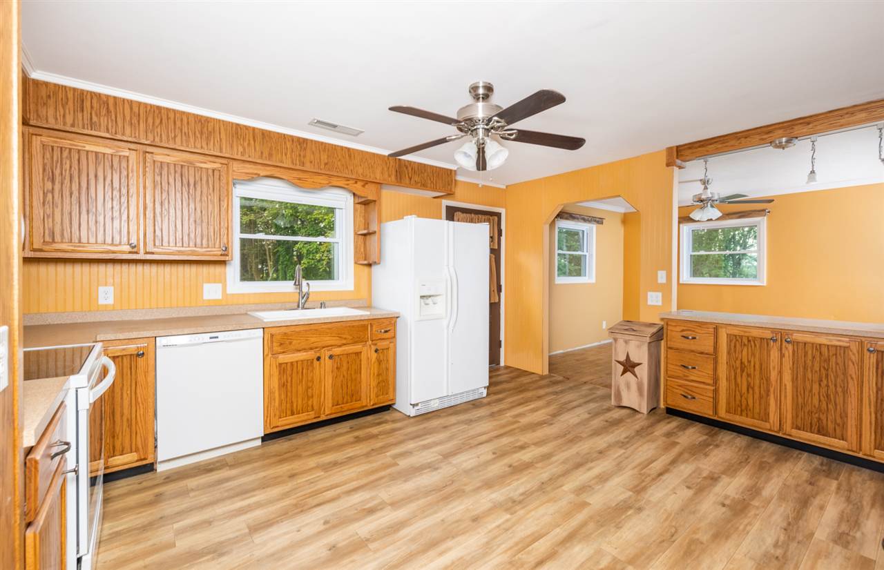 1959 Shutterlee Mill Road Staunton, VA 24401 - Photo 26 of 50 a kitchen with a refrigerator wooden cabinets and white appliances