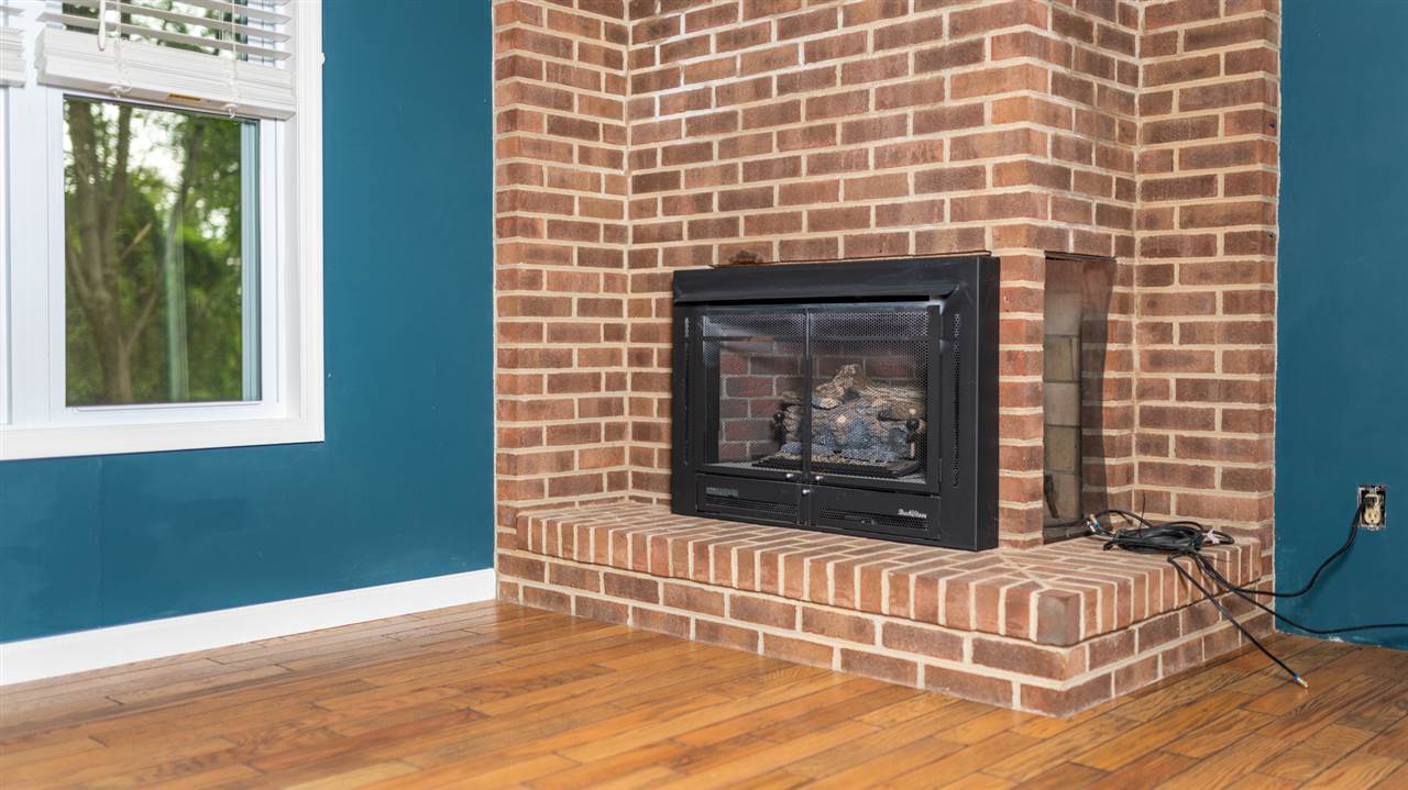 1959 Shutterlee Mill Road Staunton, VA 24401 - Photo 29 of 50 a living room with a fireplace and a wooden floor