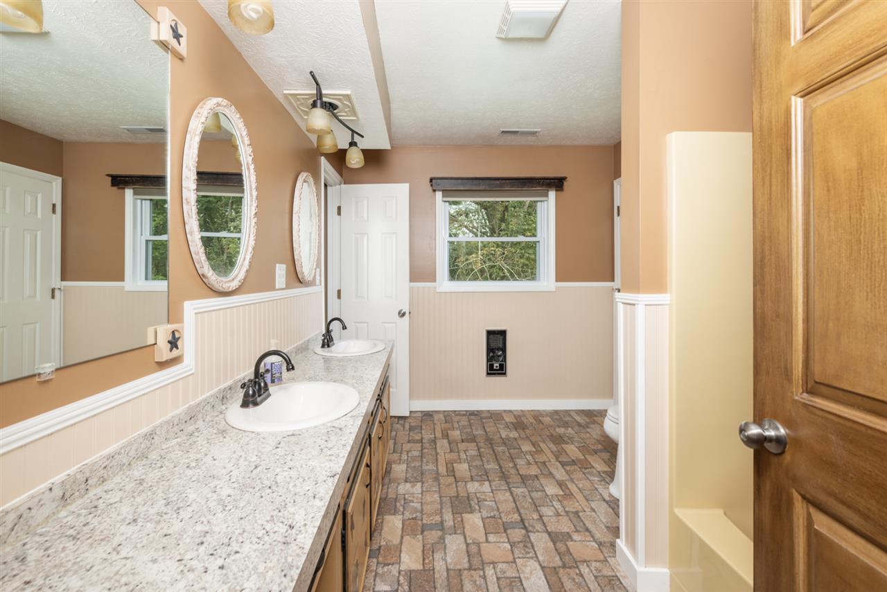 1959 Shutterlee Mill Road Staunton, VA 24401 - Photo 5 of 50 a bathroom with a granite countertop sink and a mirror