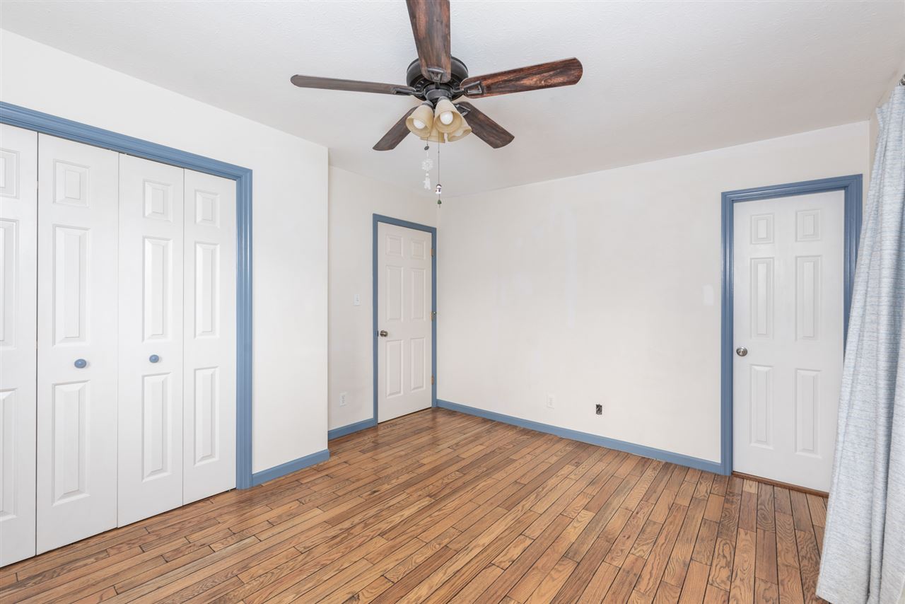 1959 Shutterlee Mill Road Staunton, VA 24401 - Photo 7 of 50 an empty room with wooden floor fan and windows