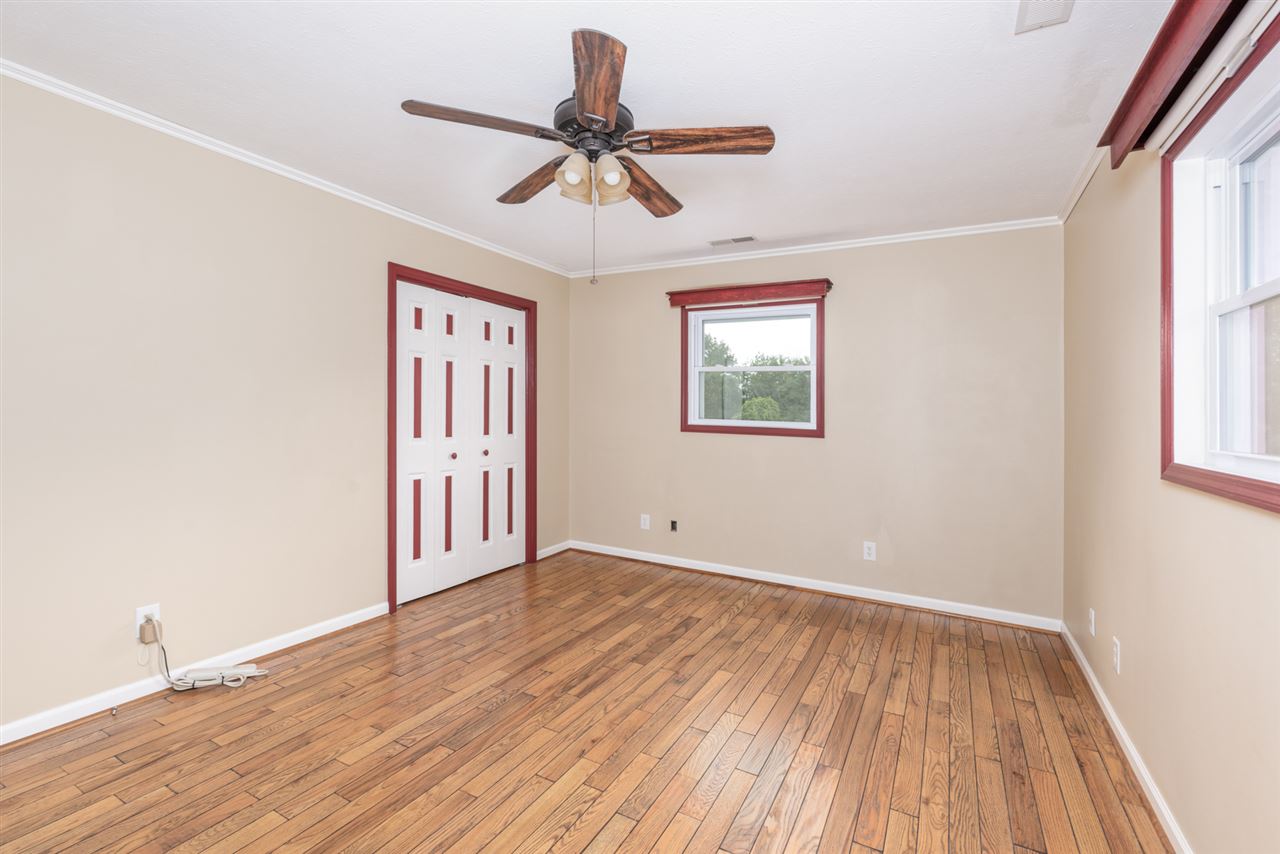 1959 Shutterlee Mill Road Staunton, VA 24401 - Photo 10 of 50 a view of an empty room with wooden floor and a window