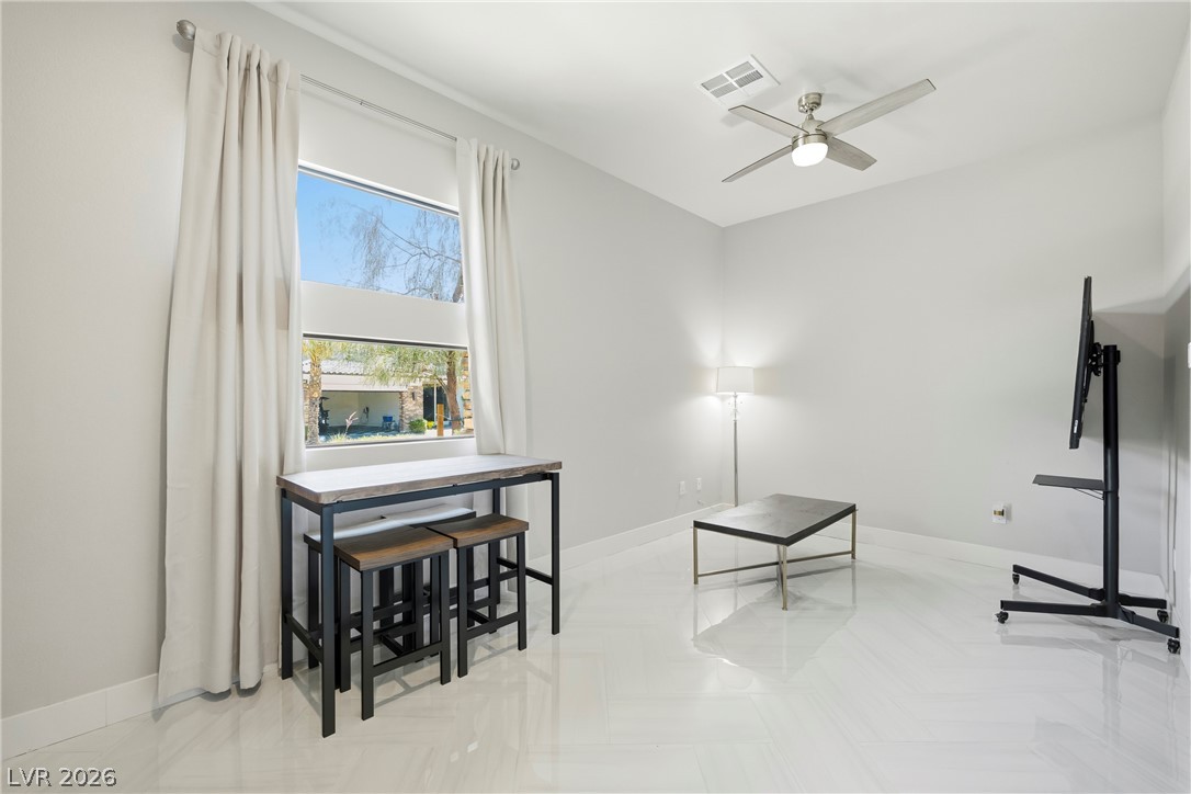 45 Garibaldi Way Henderson, NV 89011 - Photo 9 of 74 Clean lines and a luminous floor elevate this spacious, sunlit living area.