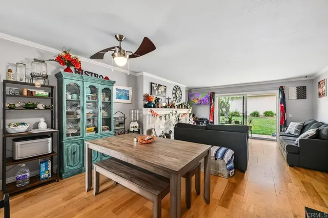 a view of a dining room with furniture window and wooden floor