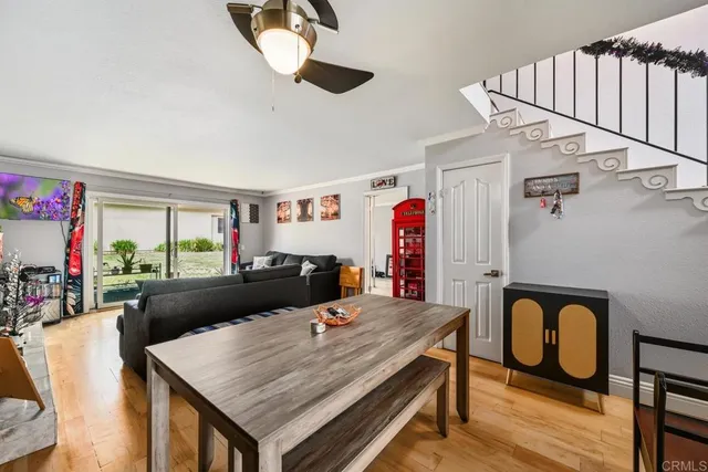 a living room with furniture a flat screen tv and a table