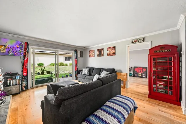 a living room with furniture and a floor to ceiling window