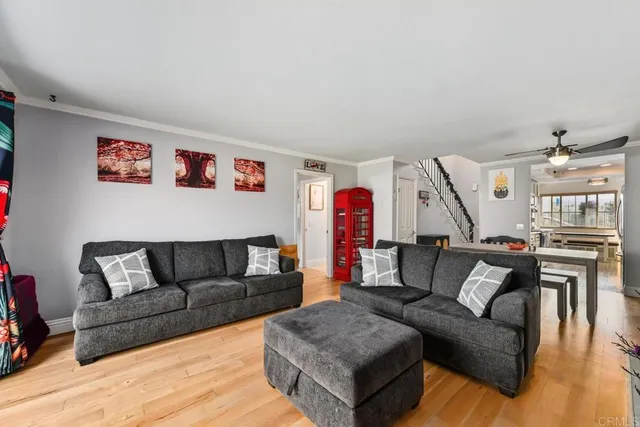 a living room with furniture and a wooden floor