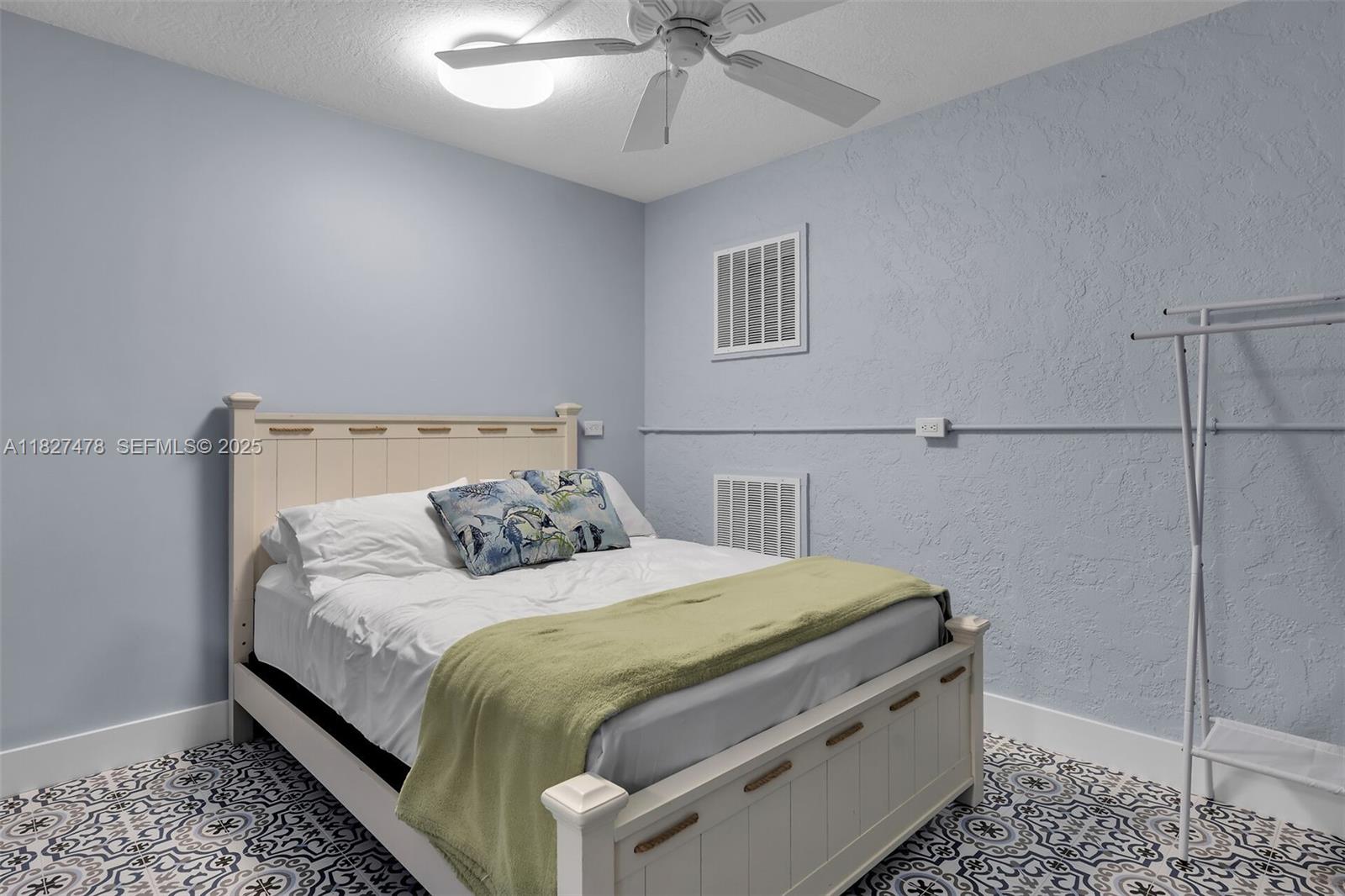 232 West Seaview Drive Marathon, FL 33050 - Photo 19 of 72 a bedroom with a bed and ceiling fan