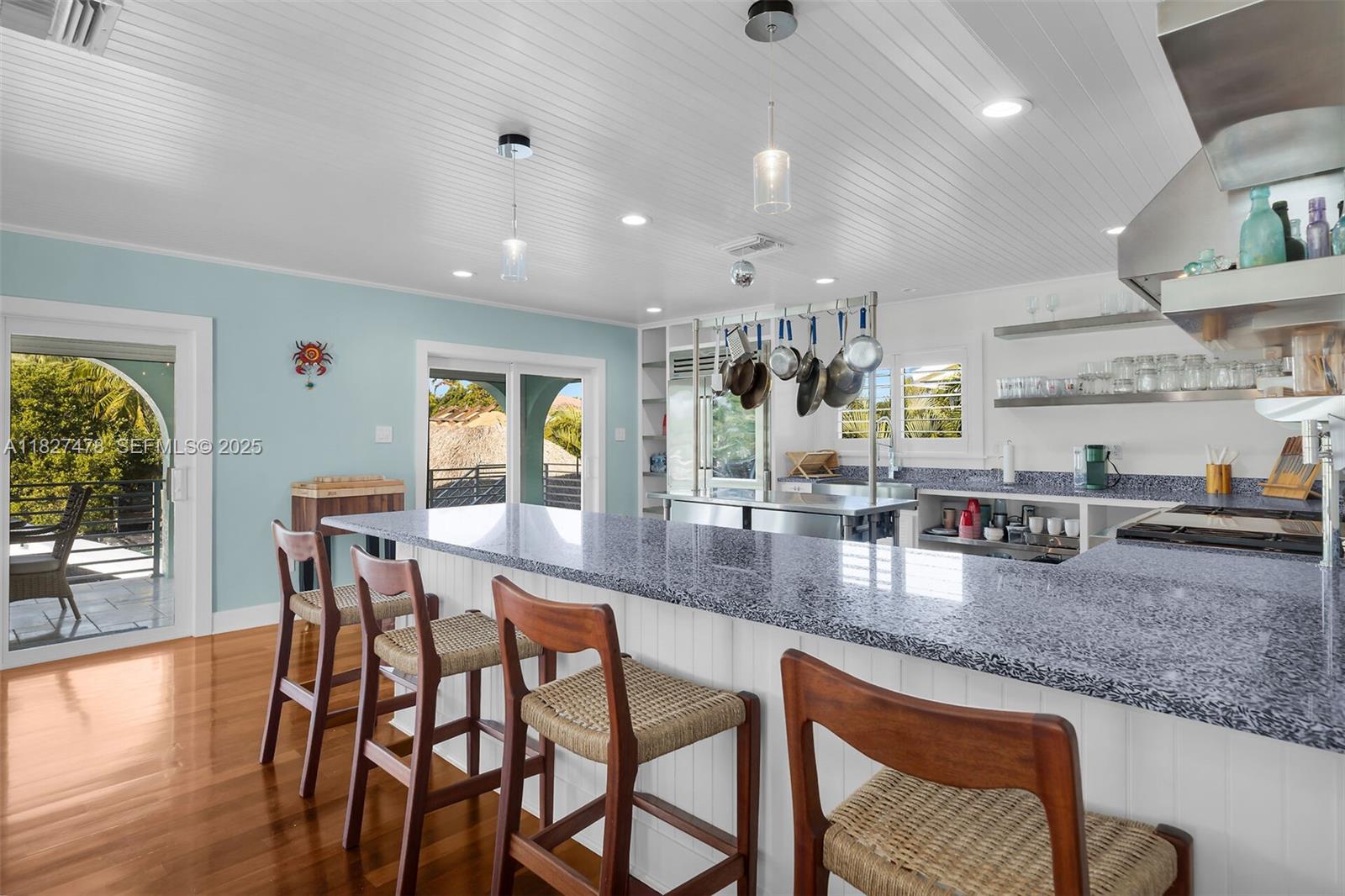 232 West Seaview Drive Marathon, FL 33050 - Photo 32 of 72 a dining area with stainless steel appliances granite countertop a stove a sink a dining table and chairs