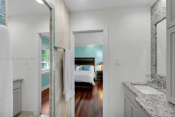 an aerial view of ocean and residential houses with outdoor space