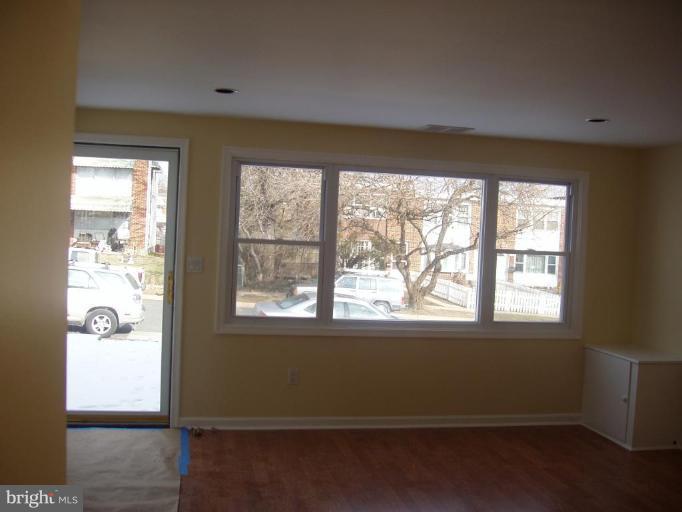 2777 Yarnall Road Halethorpe, MD 21227 - Photo 2 of 23 an empty room with wooden floor and windows