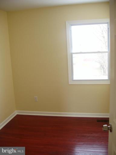 2777 Yarnall Road Halethorpe, MD 21227 - Photo 14 of 23 a view of a small space with wooden floor and a window
