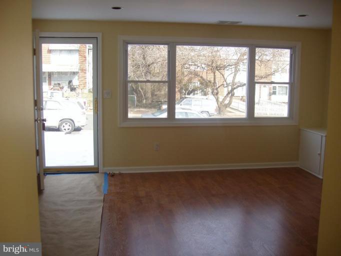2777 Yarnall Road Halethorpe, MD 21227 - Photo 3 of 23 an empty room with wooden floor and windows