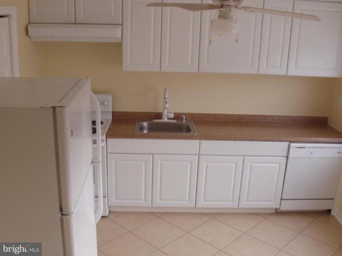 2777 Yarnall Road Halethorpe, MD 21227 - Photo 22 of 23 a kitchen with white cabinets and white appliances
