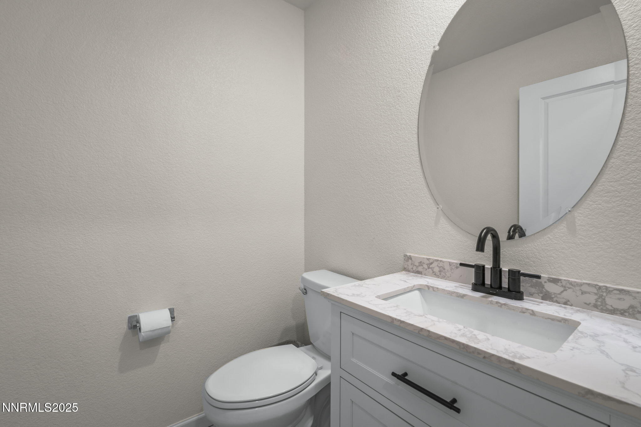 8961 Buffalo Grove Drive Reno, NV 89506 - Photo 13 of 23 a bathroom with a granite countertop sink a toilet and a mirror
