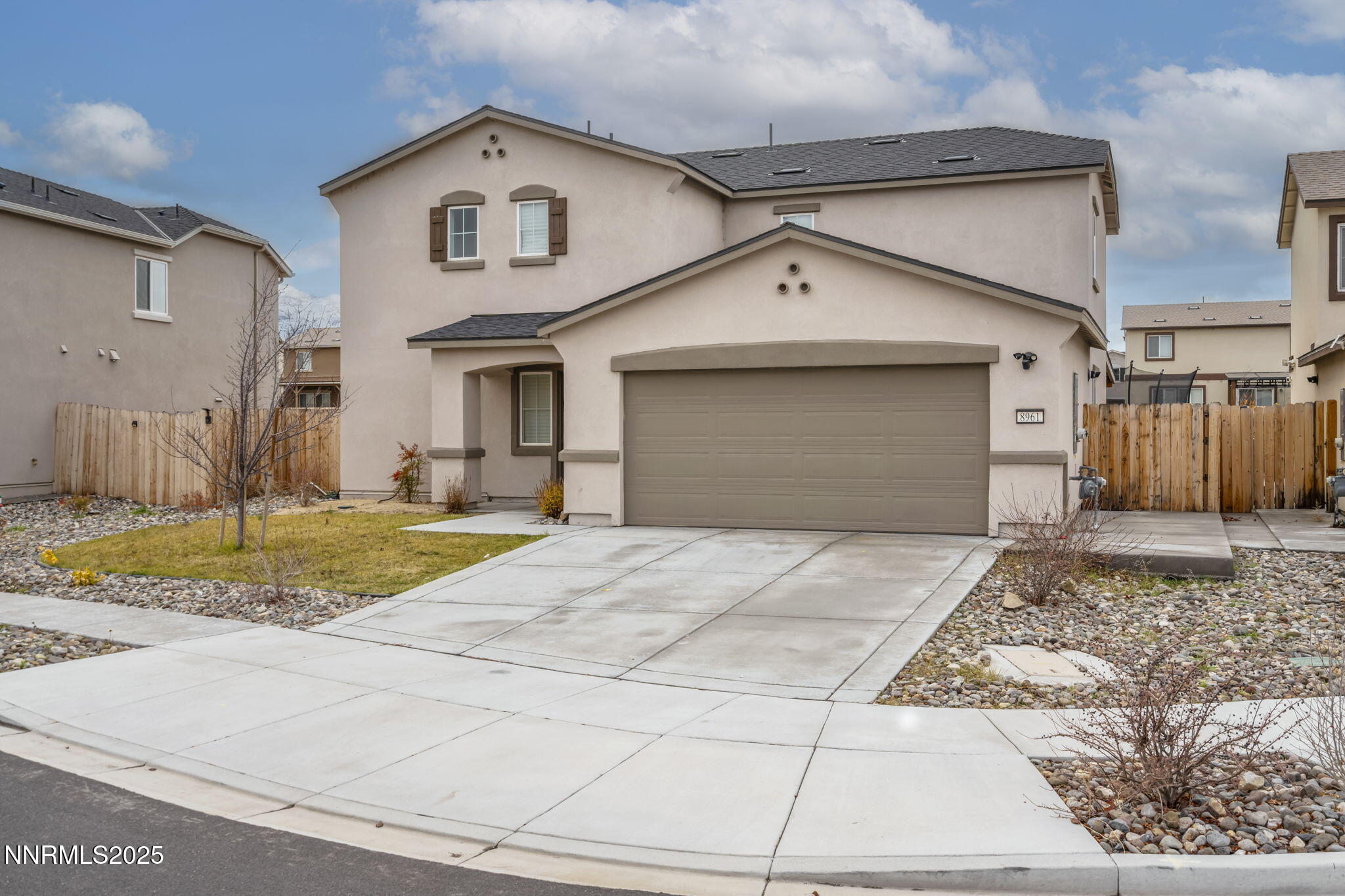 8961 Buffalo Grove Drive Reno, NV 89506 - Photo 2 of 23 a front view of a house with a yard