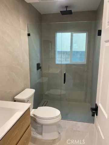 a bathroom with a toilet a sink and a shower