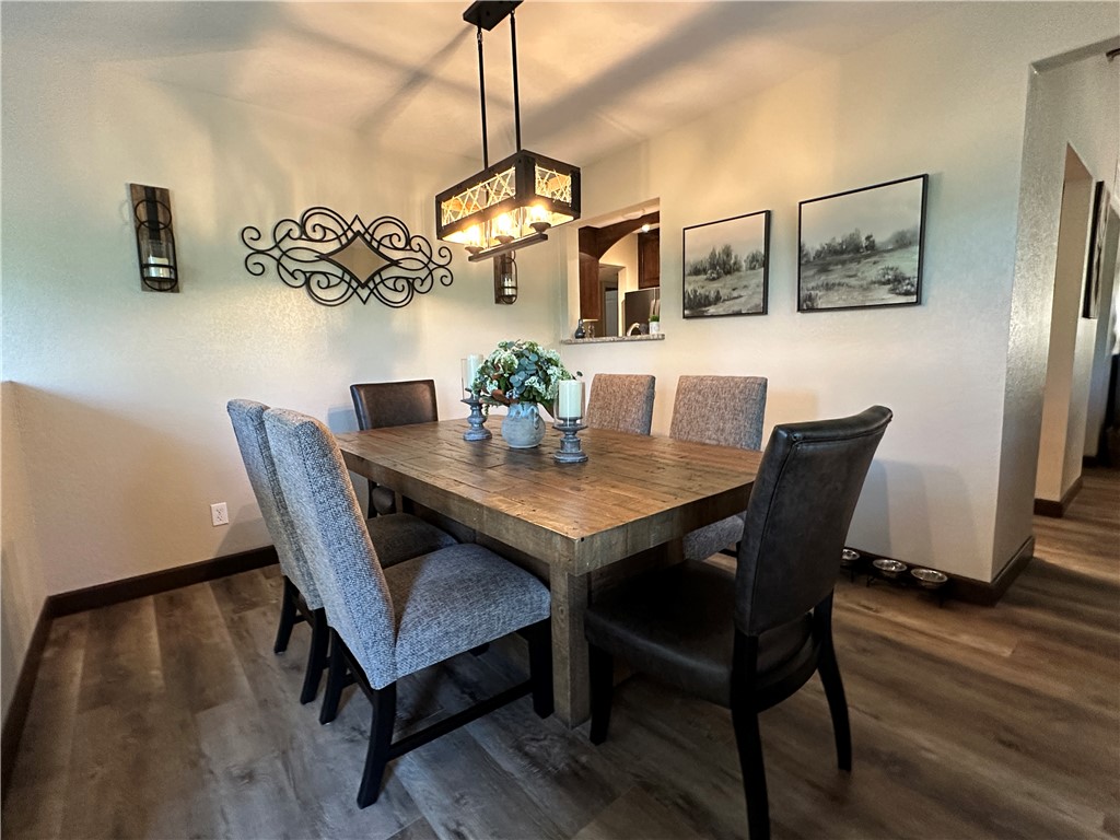 6615 Flag Mine Road Kingman, AZ 86401 - Photo 20 of 72 a view of a dining room with furniture window and wooden floor
