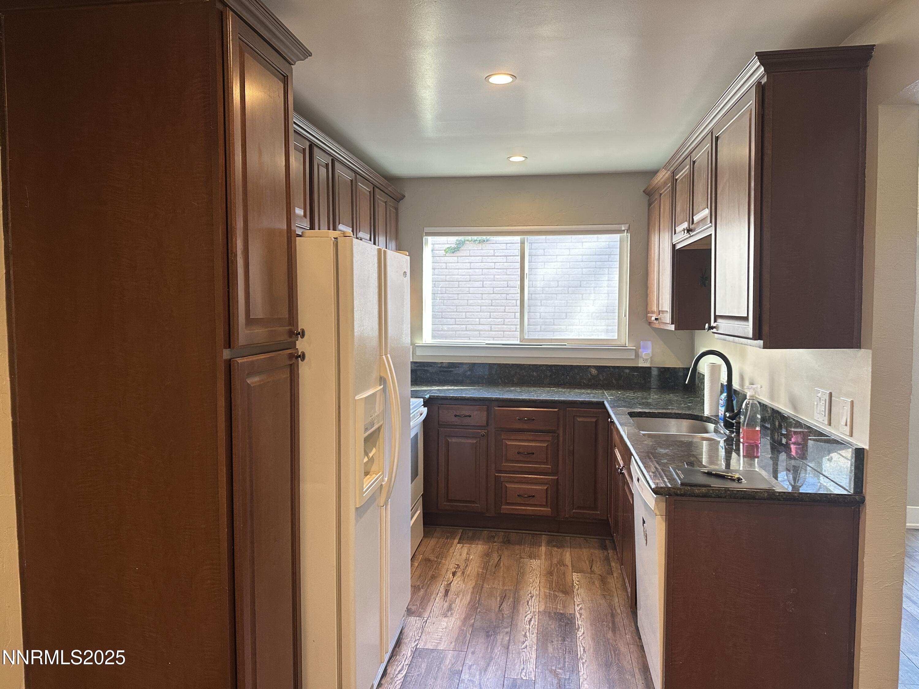 3511 Imperial Way Carson City, NV 89706 - Photo 3 of 15 a kitchen with granite countertop a refrigerator and a sink