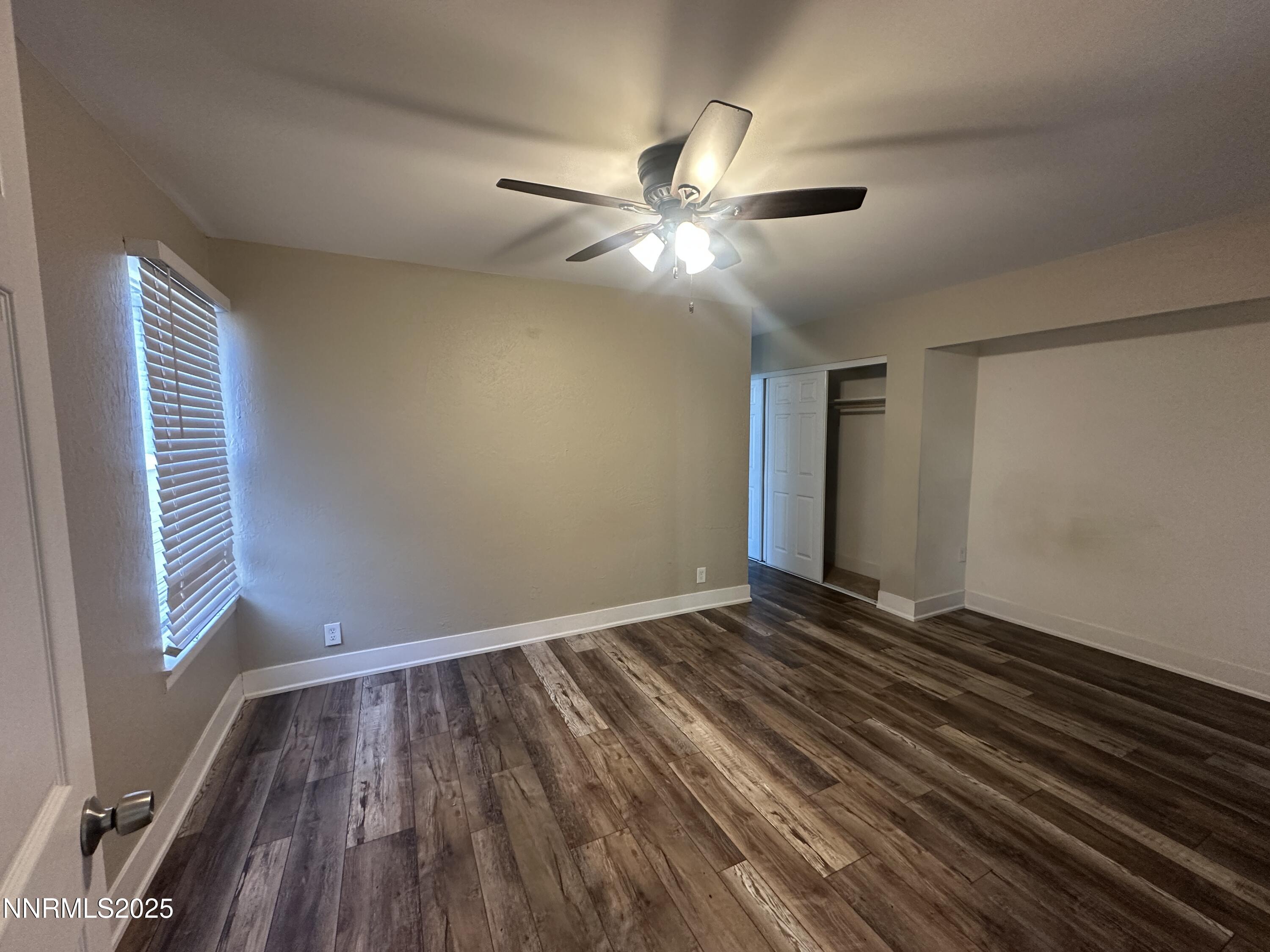 3511 Imperial Way Carson City, NV 89706 - Photo 4 of 15 a view of an empty room with wooden floor and a window