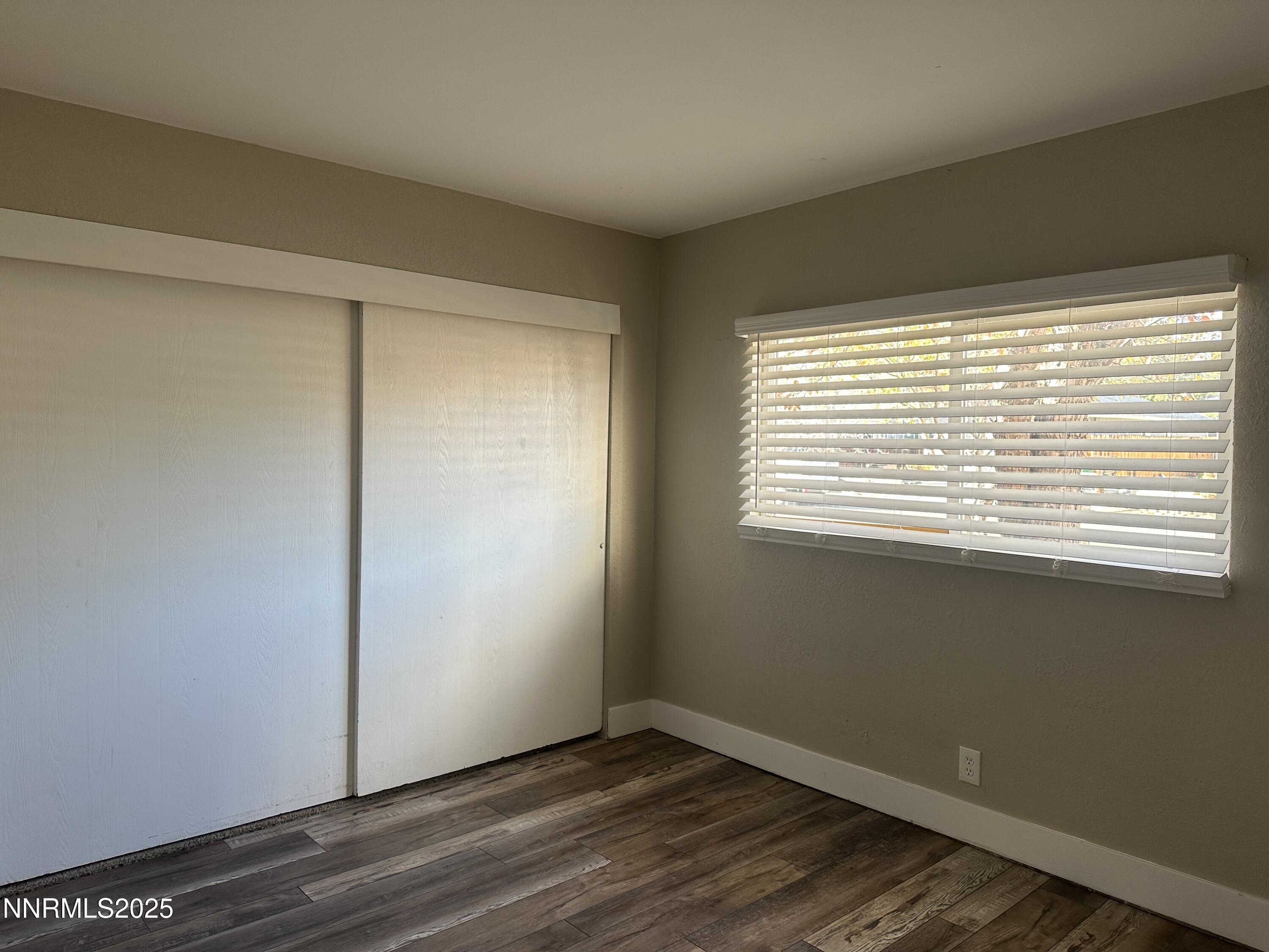 3511 Imperial Way Carson City, NV 89706 - Photo 8 of 15 a view of an empty room with wooden floor and a window
