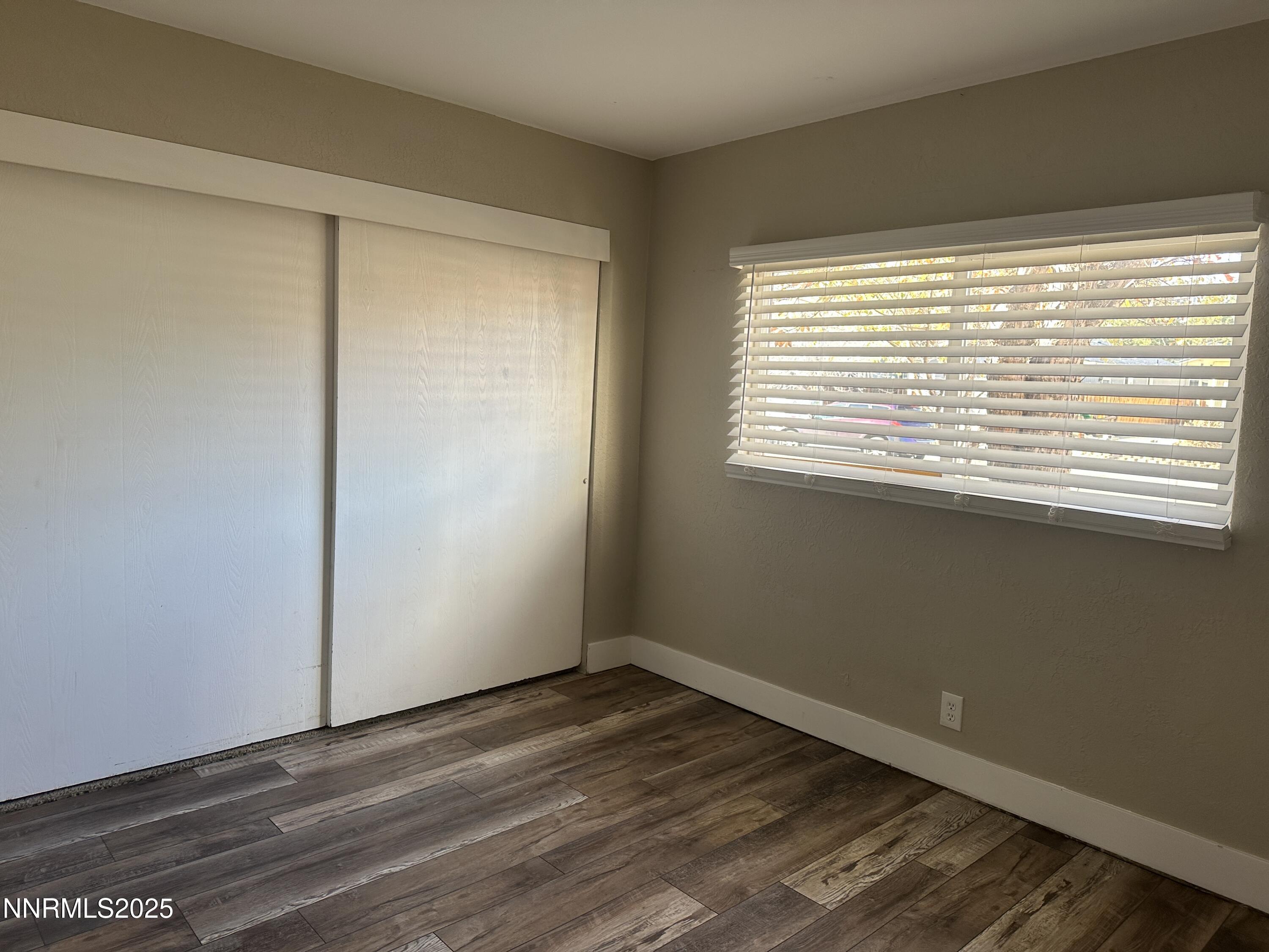 3511 Imperial Way Carson City, NV 89706 - Photo 9 of 15 a view of an empty room with wooden floor and a window