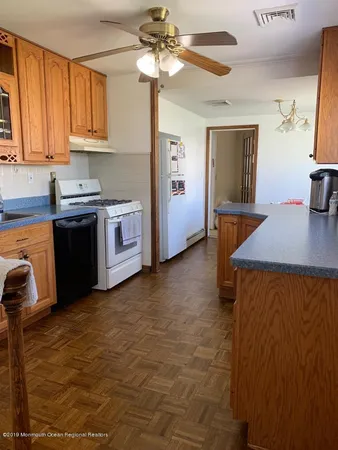 a kitchen with stainless steel appliances cabinets a sink and a stove