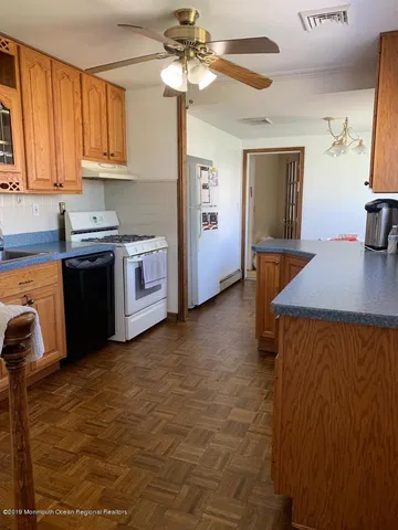 a kitchen with stainless steel appliances cabinets a sink and a stove