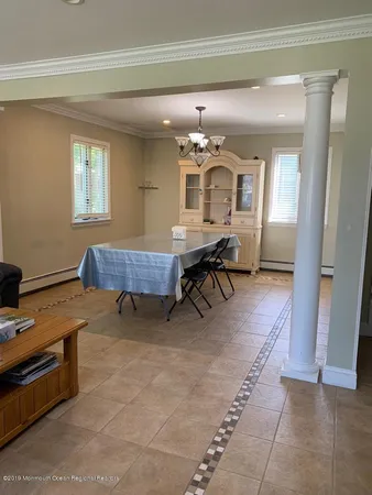 a living room with furniture and a dining table