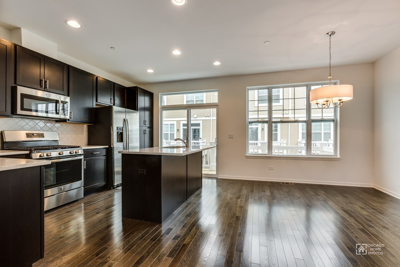1206 Elm Street Park Ridge, IL 60068 - Photo 5 of 26 a kitchen with stainless steel appliances granite countertop a refrigerator a stove top oven a sink dishwasher and wooden floor