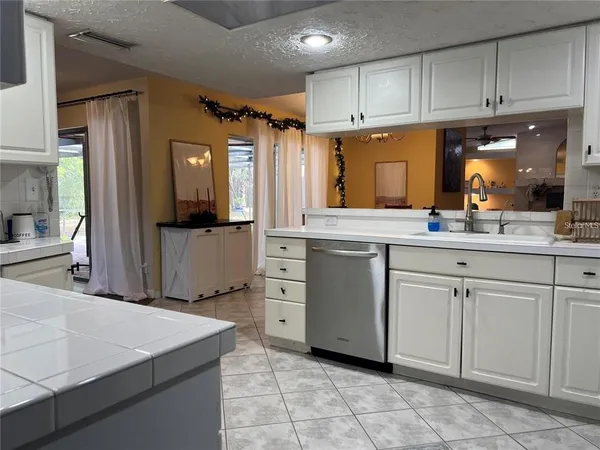 a kitchen with cabinets and window