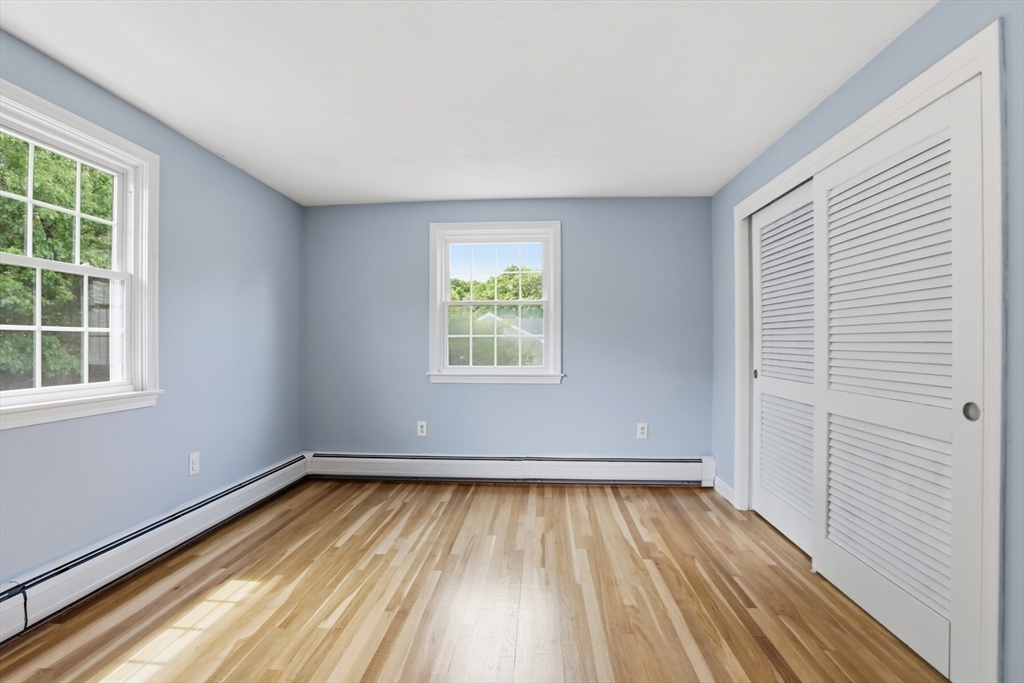 94 Johnson Road Winchester, MA 01890 - Photo 25 of 40 an empty room with wooden floor and windows